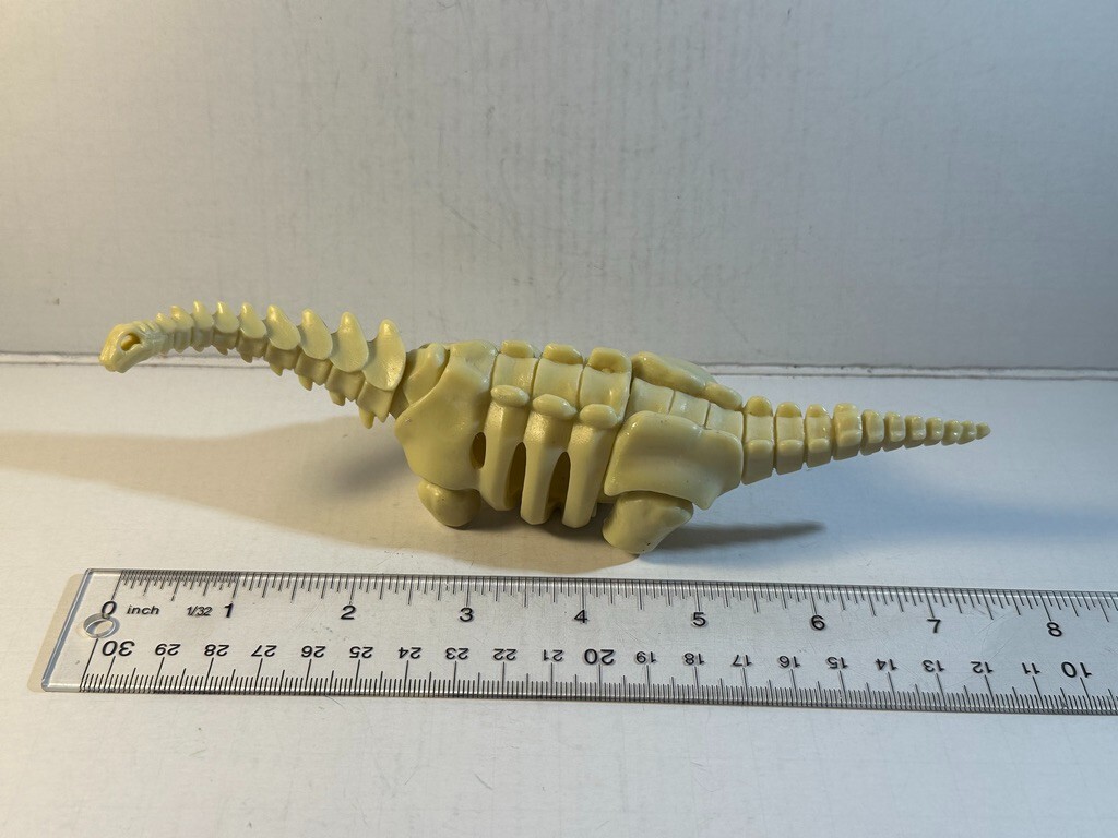 Dinosaur, Skeleton, Plastic Replica. 7.5″ long.
