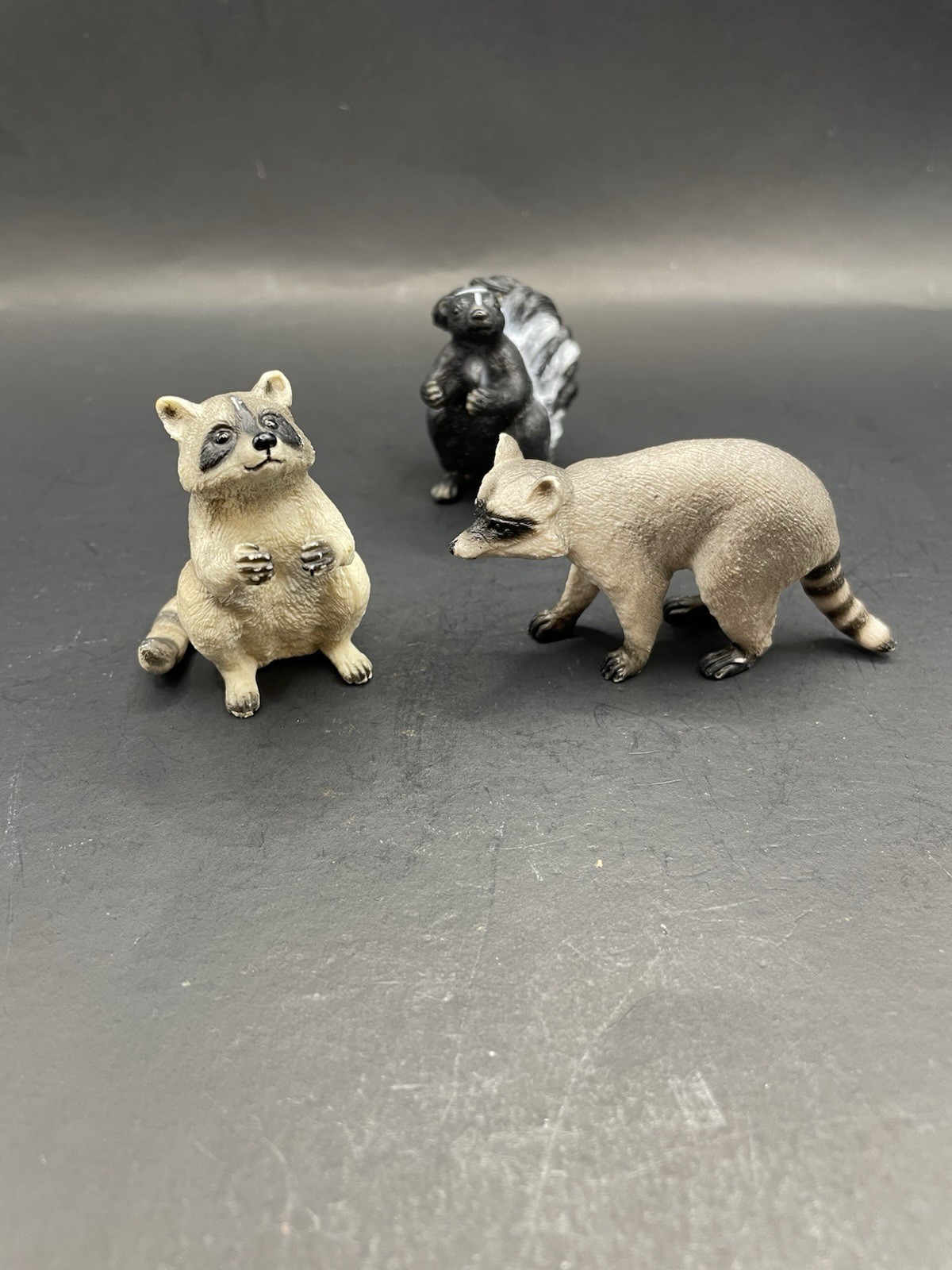 Raccoon And Skunk Figures